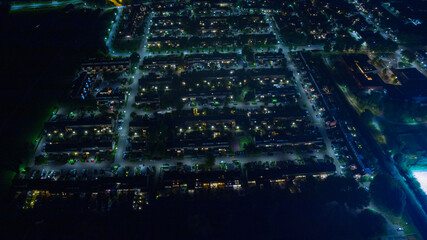 Aerial view of city by night withs lights and roads