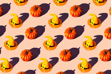 Halloween pattern made with pumpkins and witch hat.