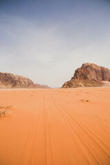 Fototapeta na wymiar car tracks in the beautiful dunes of wadi rum, Jordan, Middle East