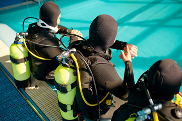 Divemaster and two divers preparing for the dive