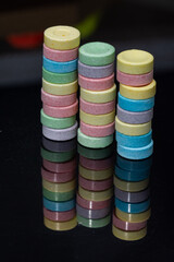colored pills on a black acrylic background