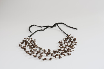 handmade necklace made of clove seeds. isolated white background