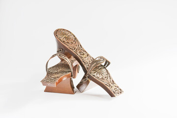 silver embroidered decorative clog figure isolated white background