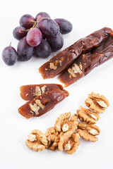 Churchkhela, national Georgian dessert made from grape juice and walnut, isolated composition on white background, copy space