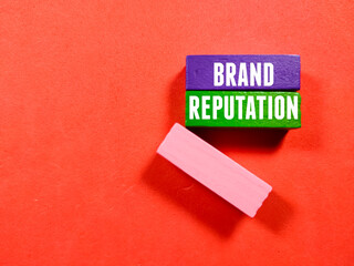 Business concept.Text BRAND REPUTATION with colored wooden block on red background.