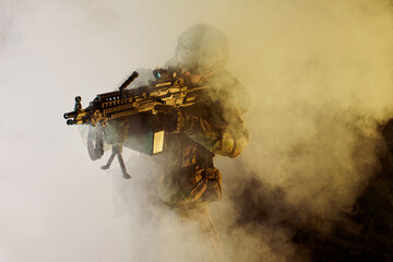 Portrait of airsoft player in professional equipment with machine gun in abandoned ruined building. Soldier with weapons at war in smoke and fog