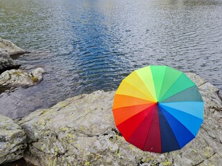 colorful ambarella against a lake of water room for text