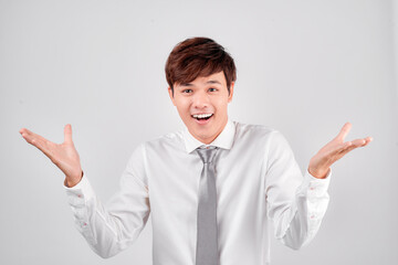 Happy asian man greeting somebody over white background. Looking at camera