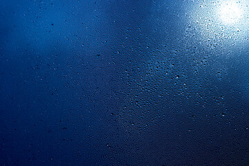 deep blue background with drops and sun glare
