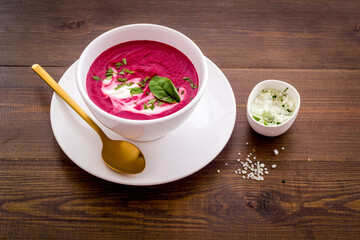 Red vegetarian beet root cream soup with herbal basil salt