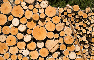 two woodpiles - one after the other small and large firewood