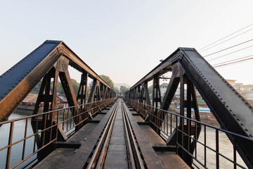 Iron bridge and railway tracks are crossing the river.