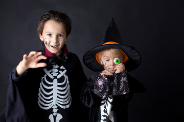 Children. brothers, dressed for Halloween, playing at home, isolated image