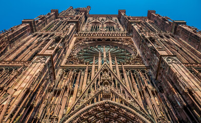 Great close-up of the famous Strasbourg Cathedral de Notre-Dame from a low angle perspective. The reddish-brown sandstone from the Vosges mountains gives the cathedral its distinctive colour.