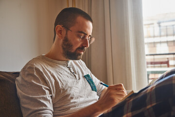 Busy middle-aged guy sitting and writing