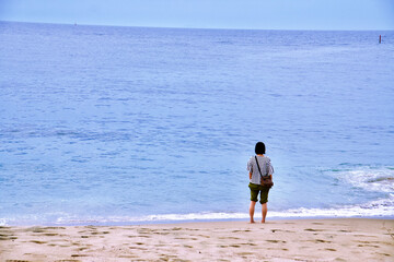 person walking on the beach