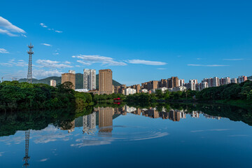 A city surrounded by lakes and forests, under the blue sky