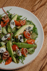 salad with salmon, avocado and cheese
