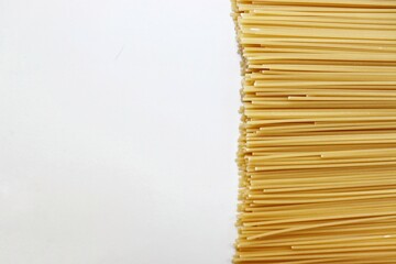 Beautiful long dry spaghetti on a white table