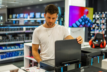 Man choosing hardware in electronics store