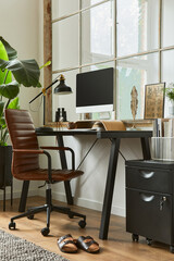 Creative composition of modern masculine home office workspace interior with black industrial desk, brown leather armchair, pc and stylish personal accessories. Template..