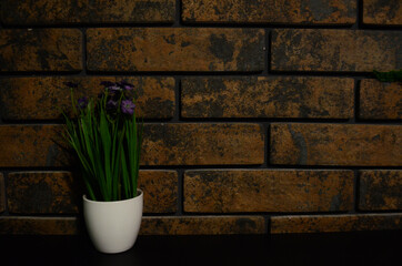 a background of a brick wall and green space