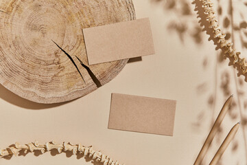 Flat lay of interior composition with mock up visit cards, textile, rocks, wood, natural materials,...