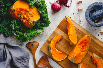 Top view of roasted pumpkin slices on a wooden board. Cooking concept, seasonal fall background.
