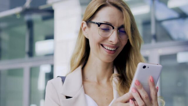Smiling attractive woman receiving message with compliments from boyfriend