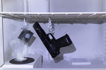 csi police, revealing fingerprints on a gun in a Cyanoacrylate fuming chamber