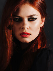 pretty red-haired woman bright makeup face close up studio