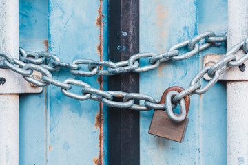 Bule locked container's door by steel chain and lock for protection