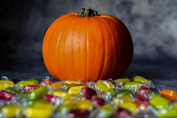 Close Up of an Orange Pumpkin With Colorful Sweets for Halloween