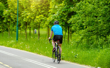 Cyclist ride on the bike path in the city Park
