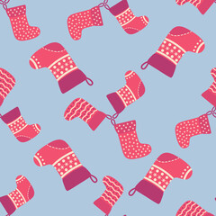 Christmas seamless pattern with red Christmas socks with snowflakes, specks