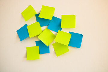 Group of yellow and blue adhesive notes on the wall