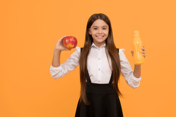 happy school child in uniform hold apple and water bottle, vitamin
