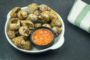 Grilled spotted babylon shell with seafood dipping sauce