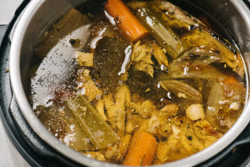 Detail of chicken bone broth cooking in an Instant Pot