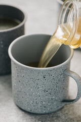 Pouring chicken broth into a mug