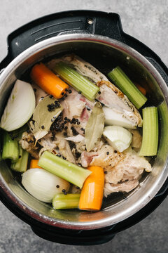 Overhead photo of ingredients used to make chicken stock in a pot