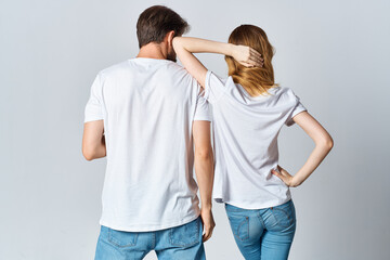 man and woman in white t-shirts and jeans design casual clothing mockup