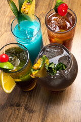 Tropical cocktails on wooden background. Frutal alcoholic cocktails.