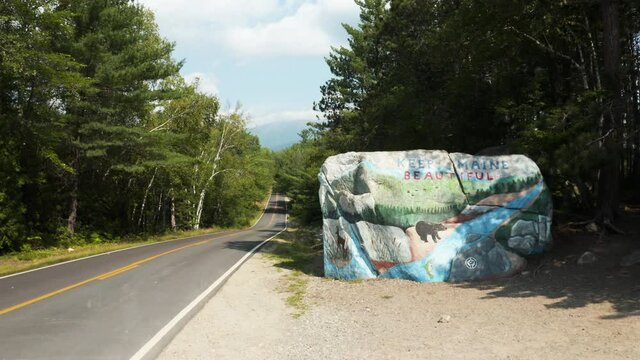Slow push forwards towards Keep Maine Beautiful Rock (Pockwockamus Rock) outside Baxter State Park, Maine