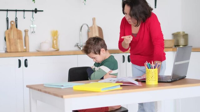 angry serious mum lecturing lazy unmotivated schoolboy, children education problem, parent and child conflict. Stressed mother and son frustrated over failure homework.