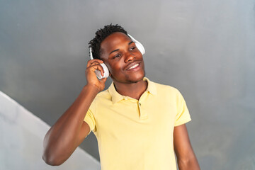young african man smiling while listening to music