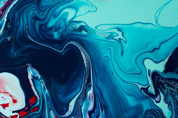 Beautiful liquid texture of the nail polish.Navy blue and red colors.Multicolored background with copy space.Fluid art,pour painting technique.Good as digital decor.