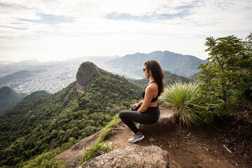 Naklejka na ściany i meble Beautiful view to hiker woman on rainforest mountain landscape