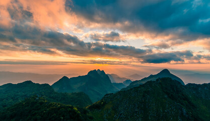 beautiful mountain peaks topped with sky, cloud and blast horizon sun