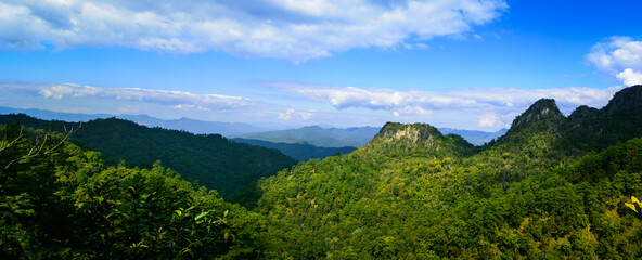 Fototapeta na wymiar Panoramic beautiful green rock mountain with clear blue sky and cloud